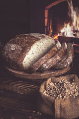 Homemade bread on the background of a home hearth