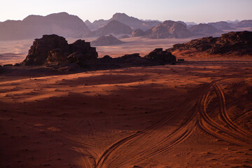 Fototapeta na wymiar Wadi Rum Desert in Jordan. On the Sunset. Panorama of beautiful sand pattern on the dune. Desert landscape in Jordan. Travel concept. Freedom