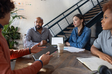 African American businessman leading a team meeting