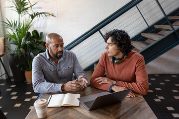 Mature businessman mentoring young entrepreneur
