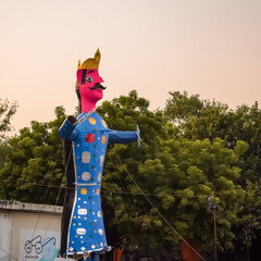 Fototapeta premium Ravnans being ignited during Dussera festival at ramleela ground in Delhi, India, Big statue of Ravana to get fire during the Fair of Dussera to celebrate the victory of truth by Lord Rama