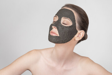 Portrait of a beautiful girl wearing a clay mask