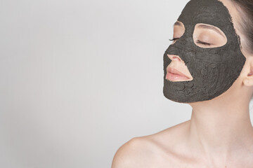 Portrait of a beautiful girl wearing a clay mask