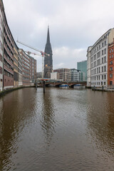 Fototapeta na wymiar Germany's second largest city Hamburg streets canals and symbolic buildings snow and colorful cloudy sky and daylight in winter