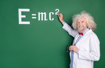 Photo of happy charming cheerful professor write chalk board equation lecture isolated on green...