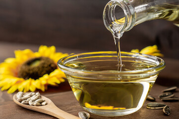 Cooking oil pouring from bottle, Sunflower seed oil, Kitchen preparing, helianthus annuus