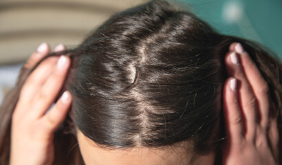 Caucasian woman showing her hair.