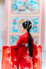 Woman dress China New year. portrait of a woman. person in traditional costume. woman in traditional costume. Beautiful young woman in a bright red dress and a crown of Chinese Queen posing.