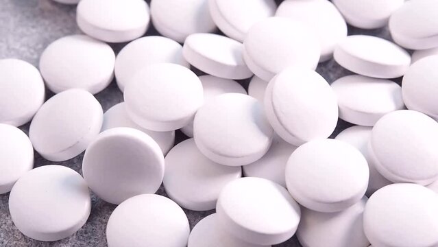 Pour the white pills out of the vials. The concept of health, treatment. Medicines and vitamins. Close-up