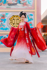 Woman dress China New year. portrait of a woman. person in traditional costume. woman in traditional costume. Beautiful young woman in a bright red dress and a crown of Chinese Queen posing.