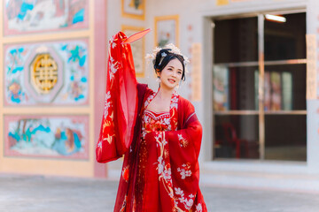 Woman dress China New year. portrait of a woman. person in traditional costume. woman in traditional costume. Beautiful young woman in a bright red dress and a crown of Chinese Queen posing.