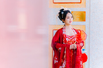 Woman dress China New year. portrait of a woman. person in traditional costume. woman in traditional costume. Beautiful young woman in a bright red dress and a crown of Chinese Queen posing.
