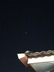 Visible star above the roof top in the night sky