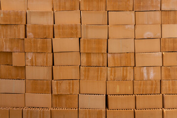 Orange clay bricks in stack. Can be used as background.