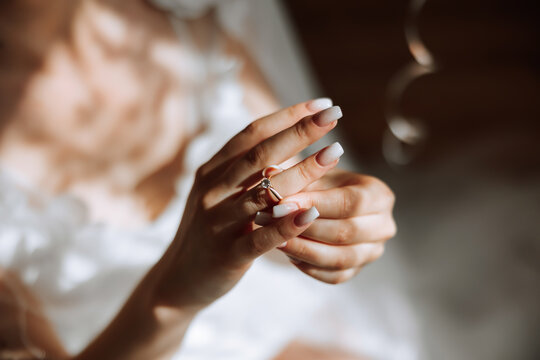 tender hands of a young woman with an expensive ring and a beautiful manicure. Close-up photo of female hands