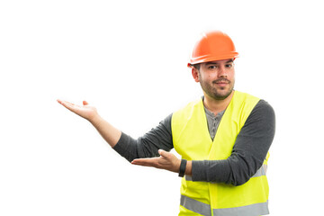 Friendly male builder smiling presenting copyspace using palms