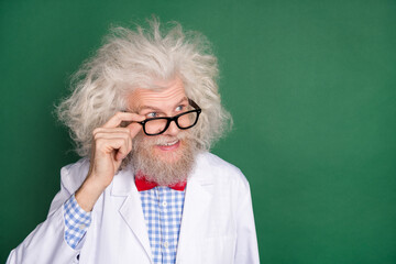 Photo of funky funny positive good mood mad crazy scientist look copyspace in glasses isolated on green color background