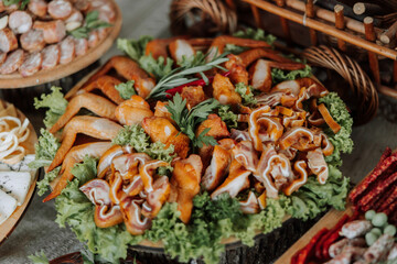 Meat and cheese snacks on the buffet. A buffet in a closed room, at a wedding celebration or birthday. Sandwiches on skewers before the start of the holiday.