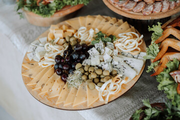 Meat and cheese snacks on the buffet. A buffet in a closed room, at a wedding celebration or birthday. Sandwiches on skewers before the start of the holiday.