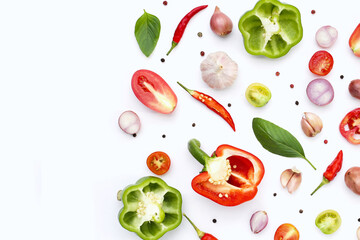 Various fresh vegetables and herbs on white background.