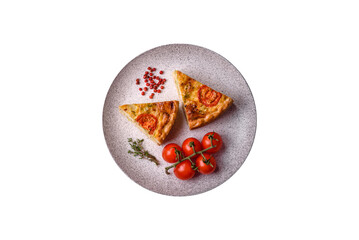 Delicious quiche with tomato, cheese, chicken, spices and herbs