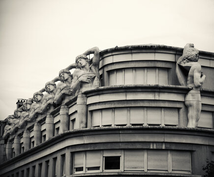 Paris, France - June 14, 2018: Architectural detail of modern building. Atlantes (based on Michelangelo&rsquo;s dying slave sculpture) by architect Manolo Nunez-Yanowski. Black white historic photo.