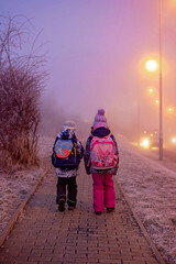 Fototapeta premium Sweet child, boy, in the morning, freezing cold weather, going to school
