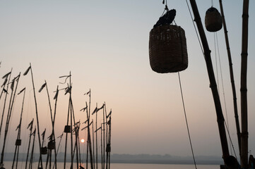 Varanasi , India - 10 December 2023 Early in the Morning Bamboos are tied on the banks of river...