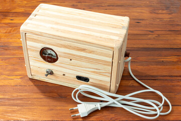 Old handmade power supply in a wooden case.