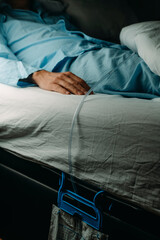 man wears a urine drainage bag lying in bed
