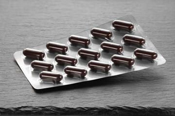 Pills in a blister. Packaging of medicines on a dark. Medicine in tablets.