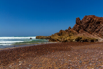 Picturesque coastal red rocks on the Atlantic Ocean coast.Legzira beach ( ore Gzira).  Morocco, Africa.