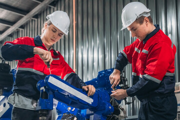 Maintenance Team Repairing Industrial Robotic Arm.