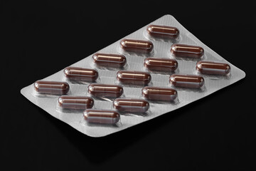 Pills in a blister. Packaging of medicines on a dark. Selective focus