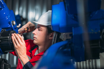 Maintenance Team Repairing Industrial Robotic Arm.