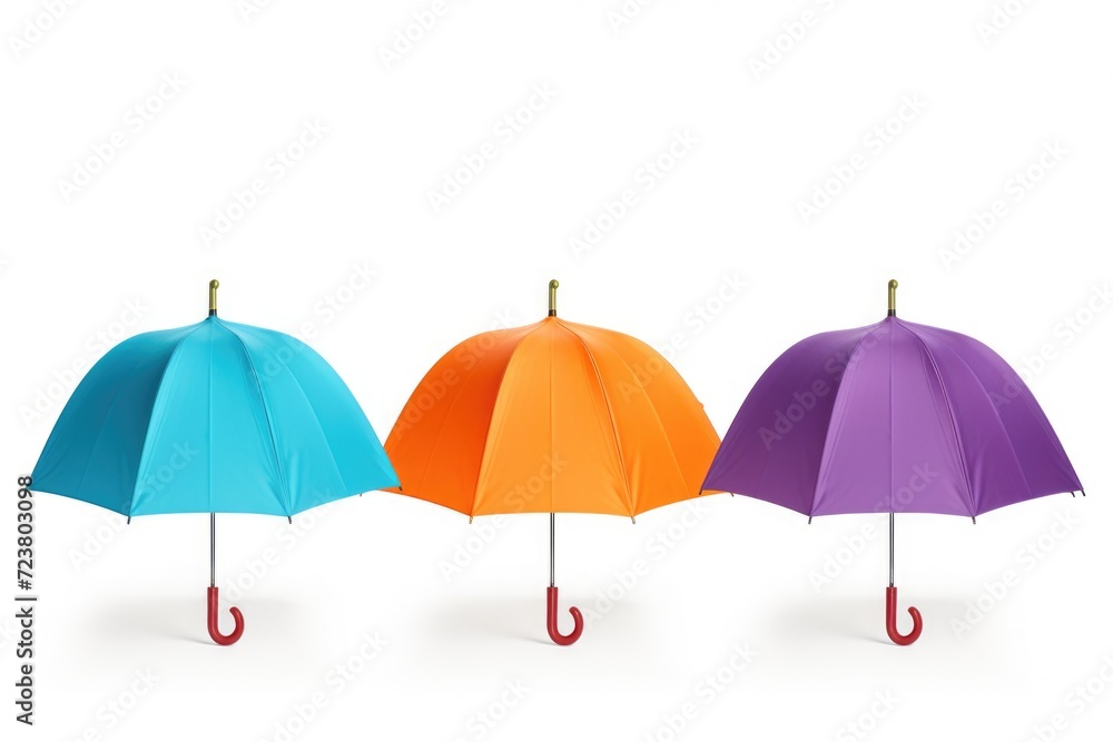 Aufkleber A group of three umbrellas sitting next to each other. Perfect for rainy day concepts or protection from the sun.