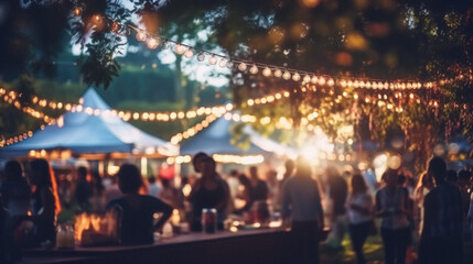 Blurred image of people at outdoor festival with bokeh lights - obrazy, fototapety, plakaty