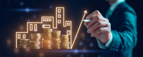 Real estate investment marketing analysis Concept business prosperity and asset management businessman using pen drawing graph line up trend of growth over the stack of coins