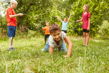 Fototapeta premium Boy crawling on grass while playing at park