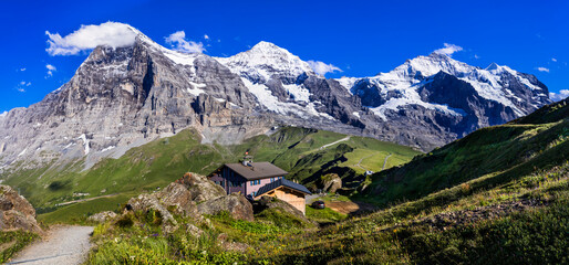 amazing Swiss nature . Kleine Scheidegg mountain pass  famous for hiking in Bernese Alps. view of highest peaks Eiger , Monc and Jungfrau, Switzerland travel - 723811817