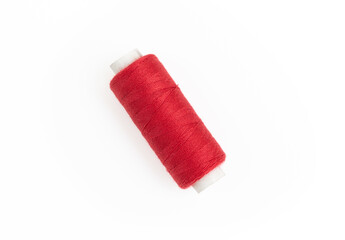 Spool of red thread isolated on a white background
