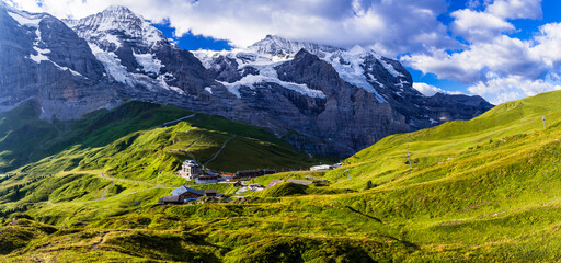 amazing Swiss nature . Kleine Scheidegg mountain pass  famous for hiking in Bernese Alps. view of highest peaks Eiger , Monc and Jungfrau, Switzerland travel - 723812295