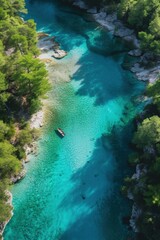 View from above of a river with crystal clear blue waters in the middle of the forest.