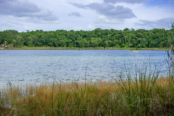 few canoes on the horizon of the   fresh water lake in the Central American jungle