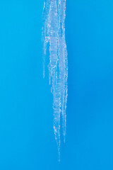 a large long icicle of ice on a blue background