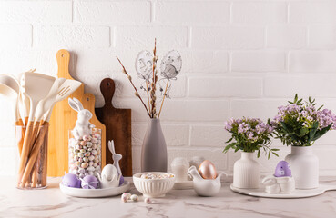 Eco-friendly kitchen utensils, wooden cutting boards, vase with willow twigs, Easter decorations....