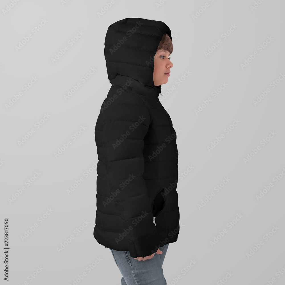 Wall mural mockup of a black winter kids puffer jacket on a girl in hoodie, side view, isolated on background.