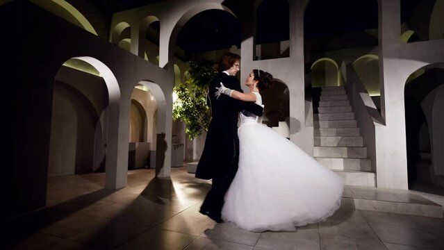 prince and princess dancing in royal palace in ballroom in night, slow motion shot