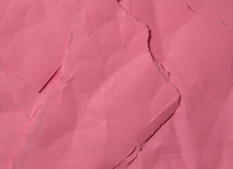 pink textured background of wrinkled backdrop paper. 