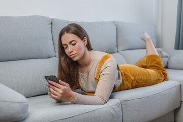 Woman Relaxing on Couch, Using Cell Phone